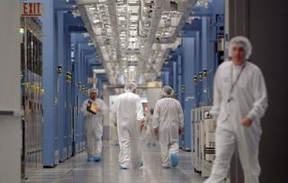 People walking around a chip manufacturing facility.